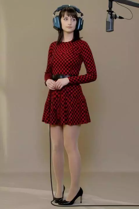 AI Video from prompt: The woman turns to face the microphone. The came