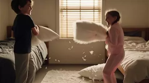 AI Video from prompt: brother and sister pillow fight before go to sle