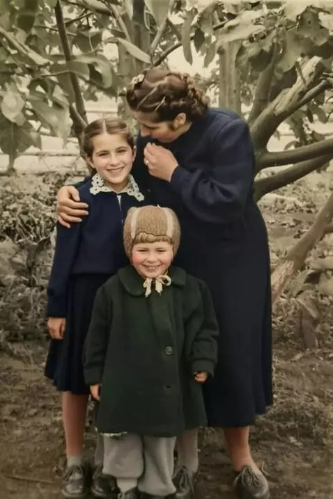 AI Video from prompt: A mother hugs her daughters, whispers a joke int