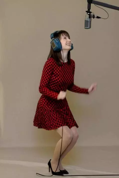 AI Video from prompt: A woman in a checkered dress successfully record