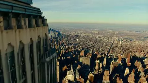 AI Video from prompt: POV you are climbing up the side of the Empire S