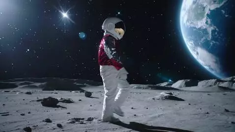 AI Video from prompt: An astronaut with silver sequin gloves and a red