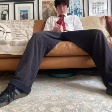 AI Video from prompt: He takes off his trousers to reveal his boxers