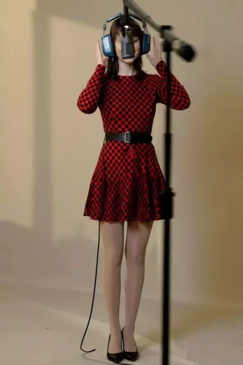 AI Video from prompt: A woman sings, holding headphones to her head. T