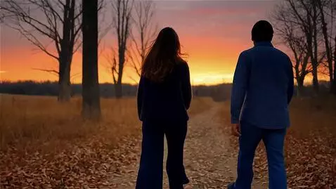 AI Video from prompt: Съёмка со спины удаляются двое: она высокая стро