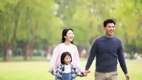 AI Video from prompt: A young, happy family consisting of a woman, a m