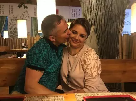 AI Video from prompt: The man continues to kiss his wife on the cheek.