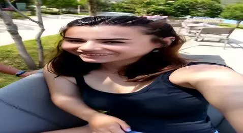 AI Video from prompt: girl reclines seductively on the sofa, her finge