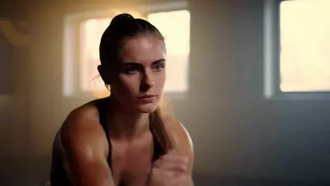 AI Video from prompt: A cinematic gym scene showing a confident young 