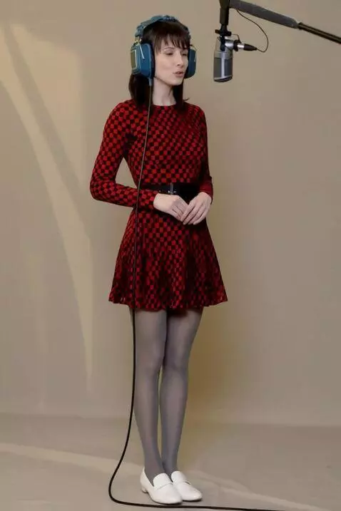 AI Video from prompt: A woman sings, holding headphones to her head. T