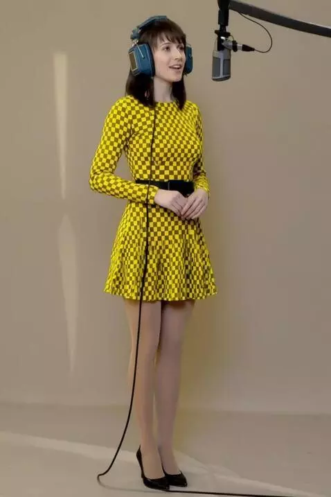 AI Video from prompt: Video of A woman sings, holding headphones to he