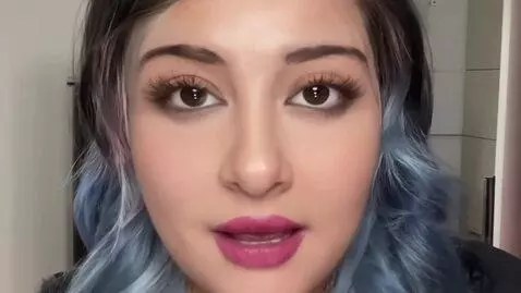 AI Video from prompt: Her breasts expand bigger than her