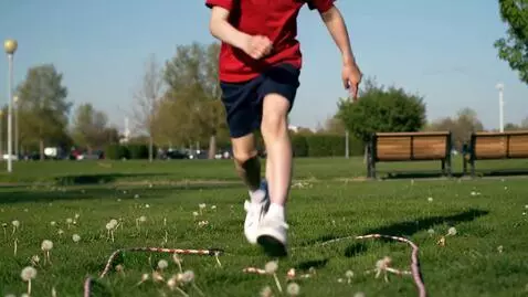 AI Video from prompt: Boy run faster and jump to rope and fall to flat