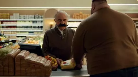 AI Video from prompt: in the supermarket, a grandfather with a gorgeou