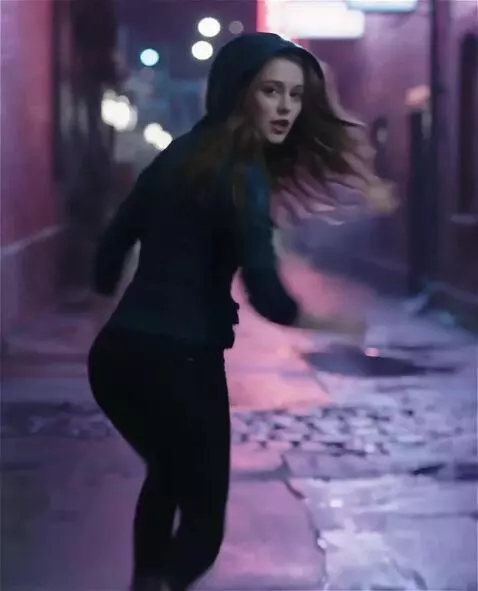 AI Video from prompt: A rainy night in a narrow neon-lit alley. A real