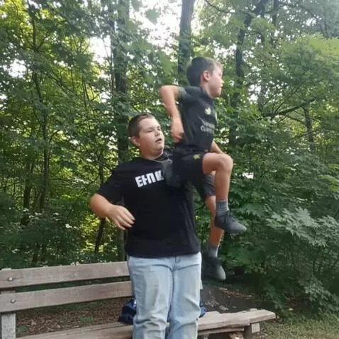 AI Video from prompt: They stand up then first guy falls through the g