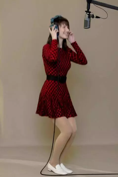 AI Video from prompt: The woman successfully recorded a take, rejoices