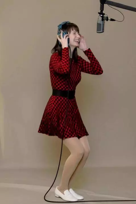 AI Video from prompt: The woman successfully recorded a take, rejoices