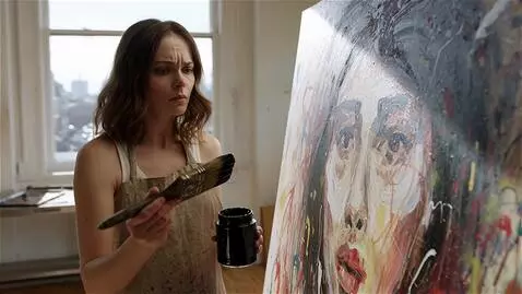 AI Video from prompt: A painter stares at her chaotic canvas. She dips