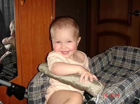 AI Video from prompt: The child sits quietly, looking at the camera. T