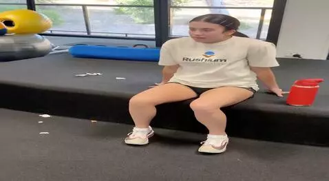 AI Video from prompt: girl stands up and lifts top up to expose tummy