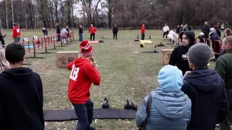 AI Video from prompt: a man in red approaches a weight that is lying i