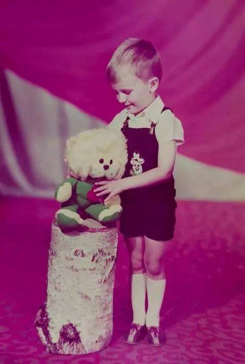 AI Video from prompt: Animate the photo: the boy picks up a plush toy 