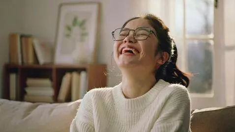 AI Video from prompt: The girl with glasses laughs