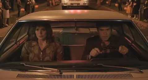 AI Video from prompt: Couple following an ambulance in their car. They