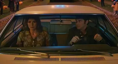 AI Video from prompt: Driving their car, they follow an ambulance as t