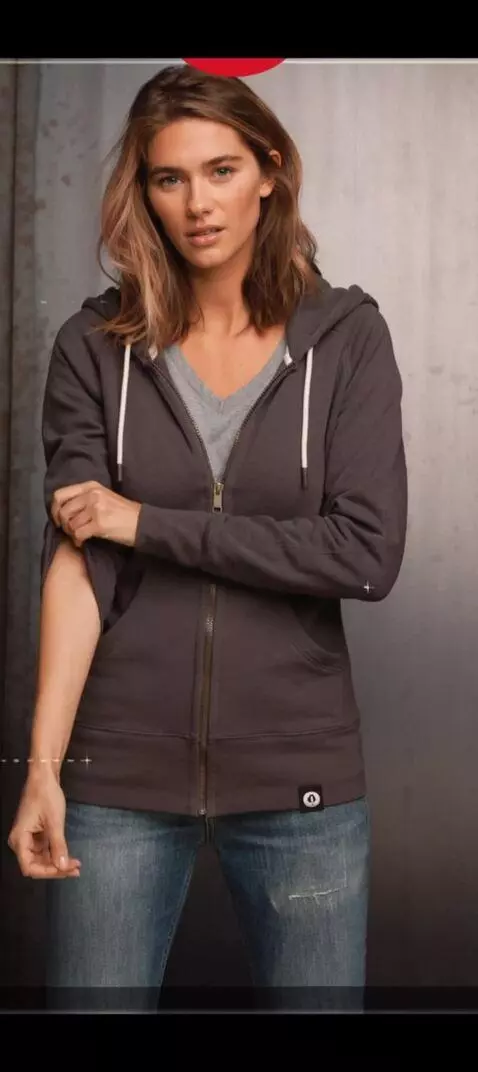 AI Video from prompt: She pulls up her right sleeve all the way up sho