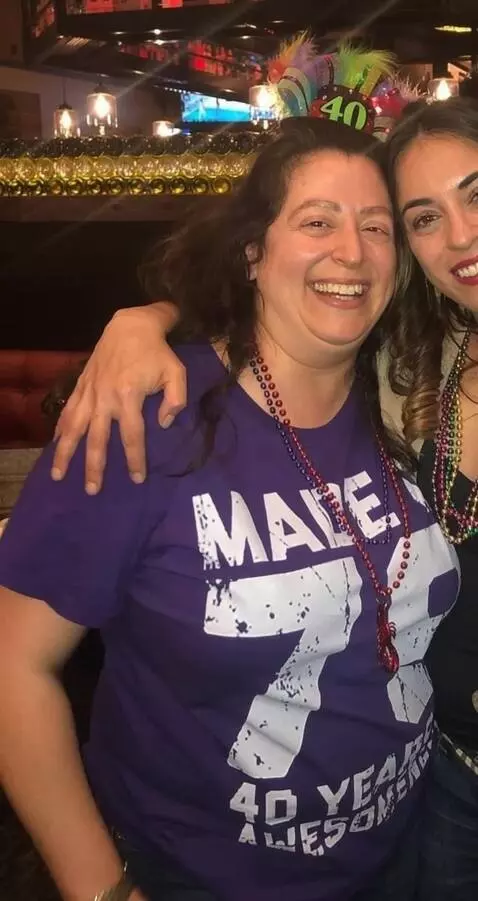 AI Video from prompt: Make her roll up her right sleeve of her shirt