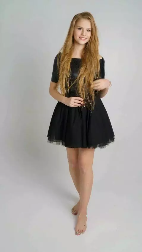 AI Video from prompt: A slender girl in a striking black dress stands 