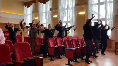 AI Video from prompt: People are actively dancing and waving their han