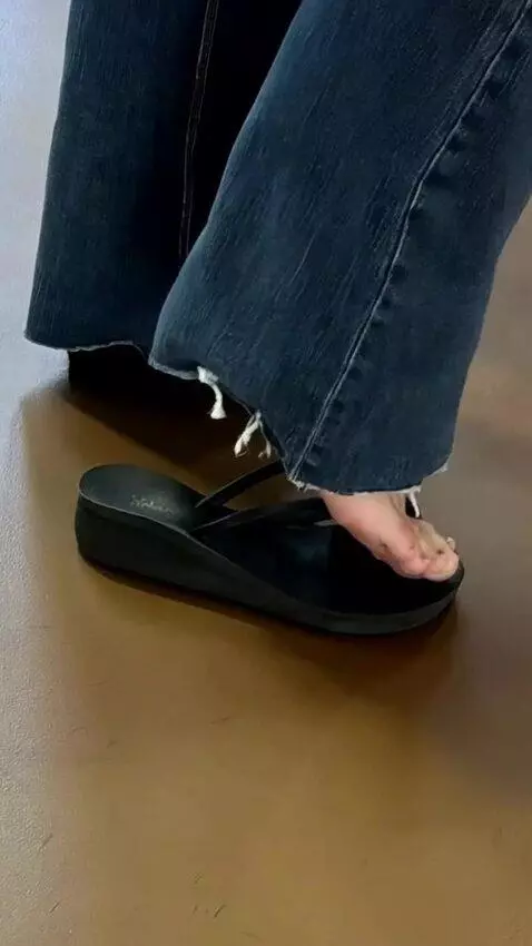 AI Video from prompt: Feet growing out of sandals, straps snap apart a