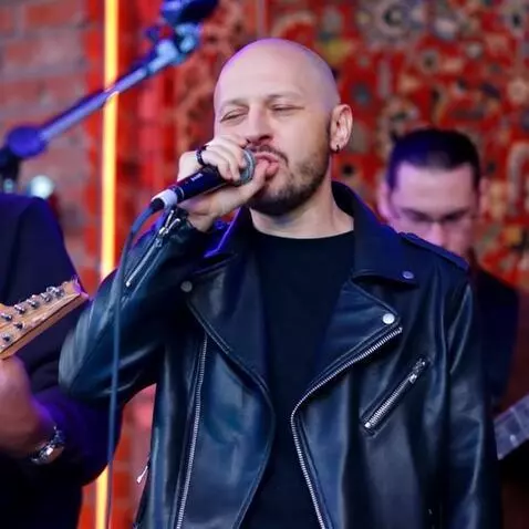 AI Video from prompt: create a video of a guy signing from photo and a