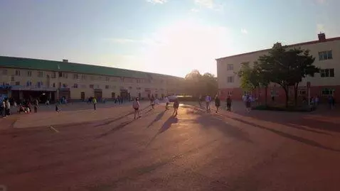 AI Video from prompt: schoolyard in the morning, sunlight, students wa