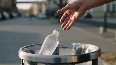 AI Video from prompt: Photo: close-up of a hand throwing a plastic bot