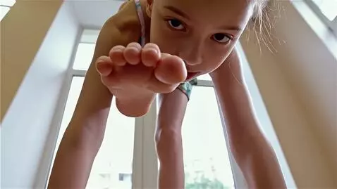 AI Video from prompt: A bottom-up view. A girl stands above, looking d