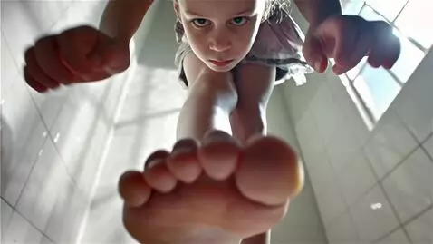 AI Video from prompt: A view from the bottom up. A girl stands straigh