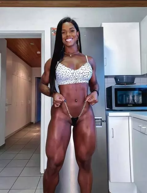 AI Video from prompt: She does pull-ups.Smiles, adjusts her hair, and 