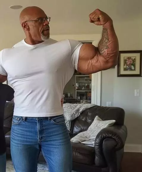 AI Video from prompt: a bodybuilder flexes his massive bicep