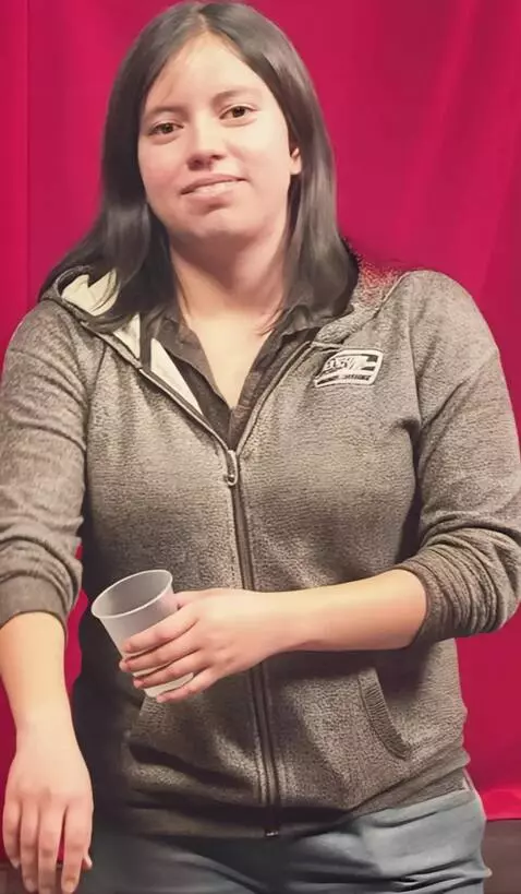 AI Video from prompt: She pulls up both of her long sleeves all the wa