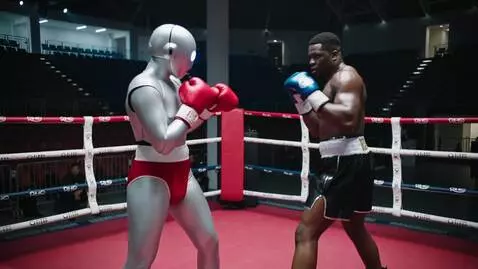 AI Video from prompt: A robot is boxing with a human.