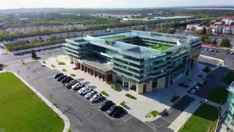 AI Video from prompt: "cinematic drone shot approaching modern 3-story