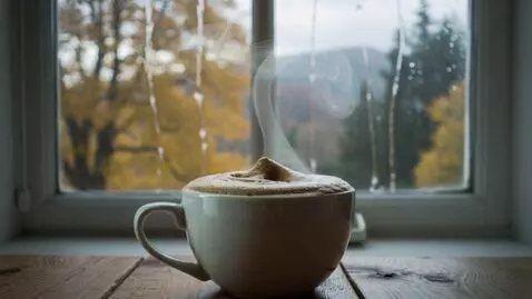 AI Video from prompt: A hot cup of coffee on the table with the window