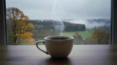 AI Video from prompt: A hot cup of black coffee on the table with the 