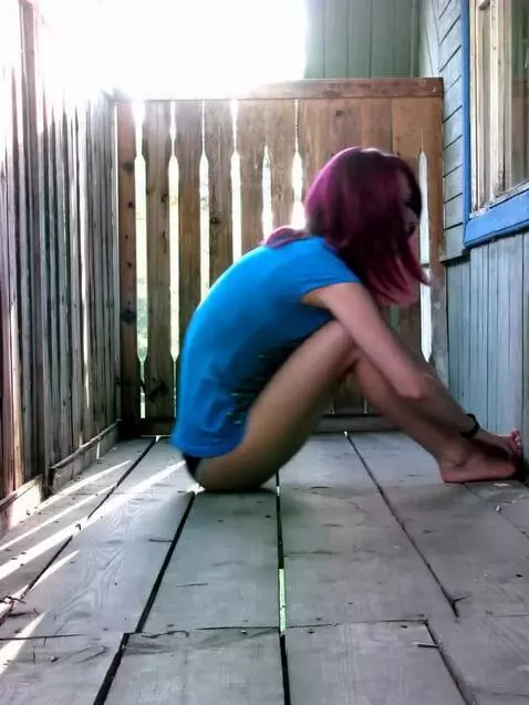 AI Video from prompt: A girl reclines on a rustic wooden terrace, her 