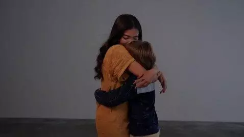 AI Video from prompt: Curvy Lara Croft hugs a boy