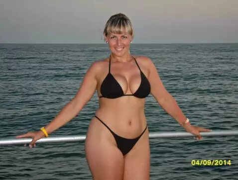 AI Video from prompt: The woman slowly sways her hips and turns her ba